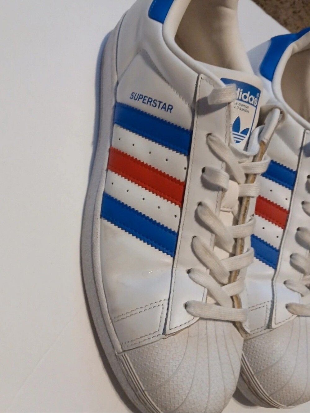 Adidas White Sneakers with Blue and Red Stripes